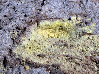 Poisonous sulfur close-up at the bottom of a volcano crater on the island of Nisyros in Greece