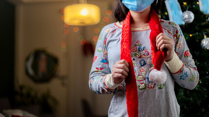 person in christmas clothes wearing a surgical mask