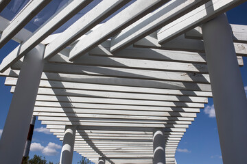 Light and shadow concept, The sunlight shines through the white wooden awning on the wall, Abstract background.