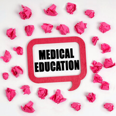 On the table are crumpled blue pieces of paper and a thought plate with the inscription - Medical Education