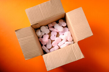 Cardboard box for gifts, top view, on an orange background