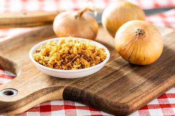 Pieces of fried onions in bowl.