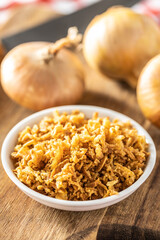 Pieces of fried onions in bowl.