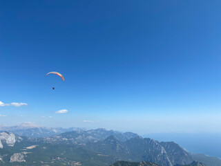 Paraglider Is Flying In The Blue Sky