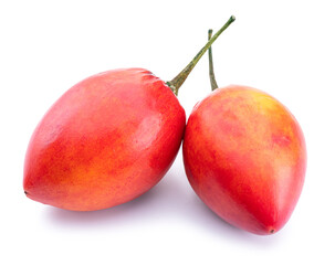 Two ripe tamarillo fruits isolated on a white background.