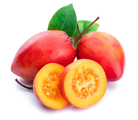 Ripe tamarillo fruits with slices and tamarillo leaves isolated on a white background.