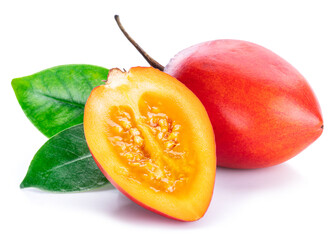 Ripe tamarillo fruits with slices and tamarillo leaves isolated on a white background.