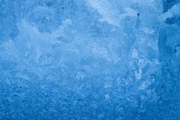 Frost pattern on a frozen window at winter. Natural background, texture