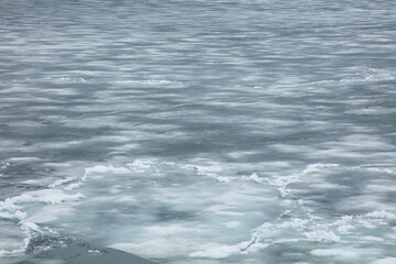 Frozen lake with cracks in the ice