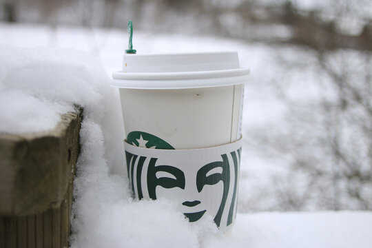 LONDON, CANADA - Jan 01, 2021: Starbucks holiday cup in a snowy cold forest