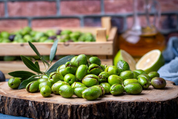 Homemade crushing olive making. Fresh green olives are breaking one by one. Crushing olives with stone. Preparing pickled olives in Turkish style. (Turkish name; kirma zeytin)