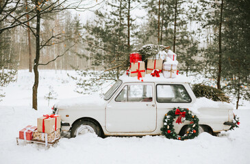 retro car decorated for Christmas with gifts among the winter forest, concept of Christmas, New Year celebration and winter holidays