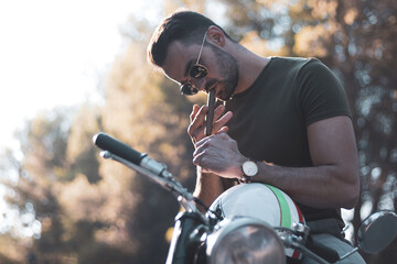 
a young biker about to ride his motorcycle.