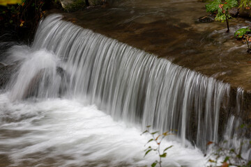 Fototapeta na wymiar a small waterfall on a stream