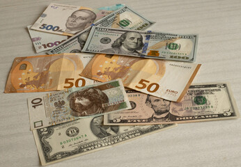 Different types of currency, banknotes of dollars, euros, Polish zloty, Ukrainian hryvnia, lying on the table