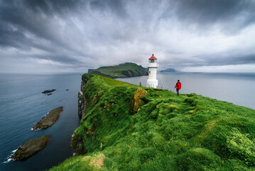 Hiking in Mykines near Holmur Lighthouse, Faroe Islands