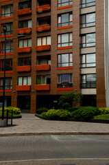 Modern urban architecture; brown walls and large black windows of apartments, offices, companies.