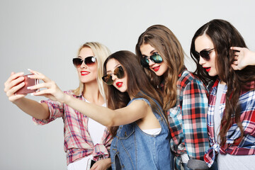 Fototapeta na wymiar happy teenage girls with smartphone taking selfie