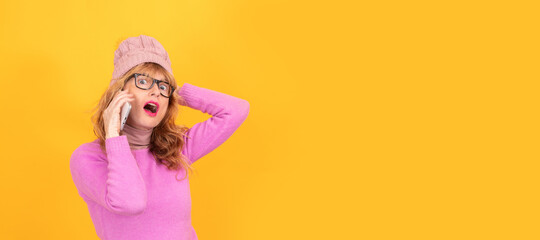 woman wearing winter clothes and mobile phone isolated on background