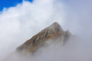 Landscape with clouds on mountain ridges