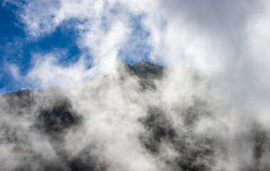 landscape with clouds on top of mountain ridges