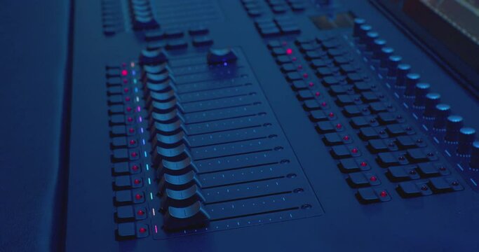 modern studio equipment. electronic console for sound control. equalizers move on the mixer.