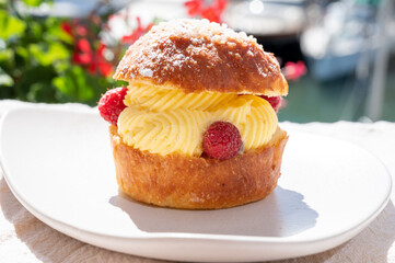 Tarte tropezienne or La Tarte de Saint-Tropez - dessert pastry consisting of filled brioche with cream and fresh berries.