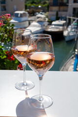 Summer on French Riviera Cote d'Azur, drinking cold rose wine from Cotes de Provence on outdoor terrase in Port Grimaud, Var, France