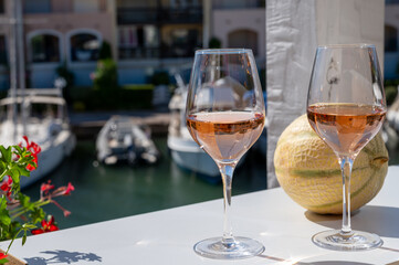 Summer on French Riviera Cote d'Azur, drinking cold rose wine from Cotes de Provence on outdoor terrase in Port Grimaud, Var, France