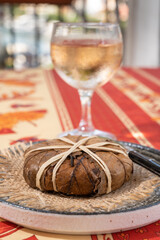 Taste of Provence, ancient small goat cheese Banon a la feuille wrapped in chestnut leaves and tied with raffia served with rose wine
