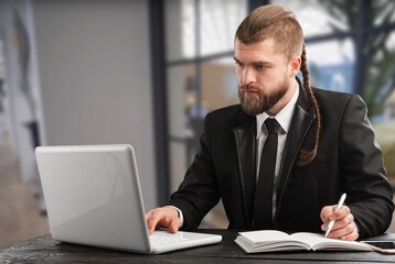 Mature business man using laptop computer having video conference call