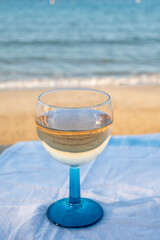 Summer time in Provence, drinking of cold gris rose wine on sandy beach and blue sea near Toulon, Var department, France