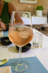 Summer on French Riviera Cote d'Azur, drinking cold rose from Cotes de Provence on outdoor terrase in old cafe, Var, France