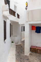 White bright houses with wooden windows on a typical Mediterranean fisher village in Menorca, Spain