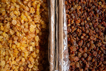 Beautiful raisins on the market counter. Dried fruits close-up.