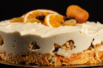 Carrot cake raw dessert with cashew cream on the black background