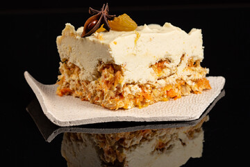 Carrot cake raw dessert with cashew cream on the black background