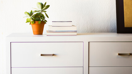 Interior of a stylish white and bright apartment with a close-up into a white furniture