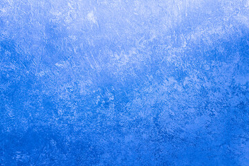 An old blue cement wall. Cold, blue background with cement texture.
