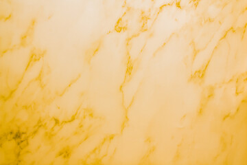 The wall is made of yellowed marble. Yellow background with marble texture.