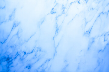 The wall is made of blue marble. Cool, blue background with marble texture.
