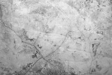 Concrete wall with scuffs and cracks of gray color. Gray background with cement texture.
