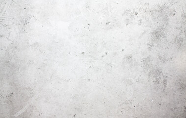 Fototapeta na wymiar A concrete wall with dots and scuffs of light gray color. Light gray background with cement texture. 