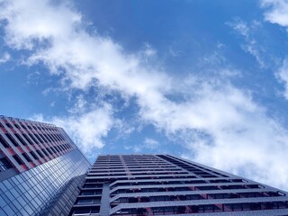 Modern building against cloudy sky. Multi story residential house. Urban high-rise skyscraper in city. Condominium building.