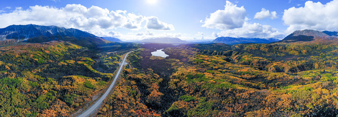 Panoramic aerial view of road leading to Haines Junction in northern Canada during autumn, fall...