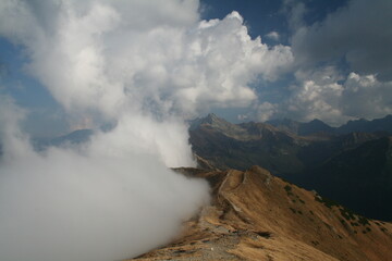Clouds in mountains. Weather change.