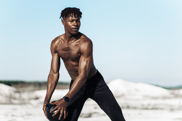 African American crossfit man, fitness man holding abdominal workout ball, outdoors
