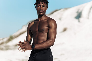Portrait african american man, fitness athlete, with muscular naked torso, outdoors in nature