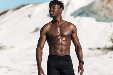 Portrait african american man, fitness athlete, with muscular naked torso, outdoors in nature