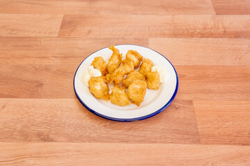 Cod tacos battered with flour and egg fried in olive oil and accompanied by mayonnaise sauce to dip